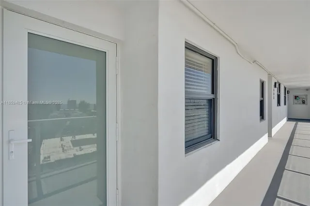 a view of a chairs and table in patio with a small yard