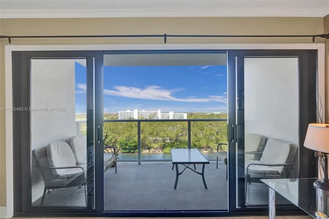 a view of a room that has a bed and a table in it