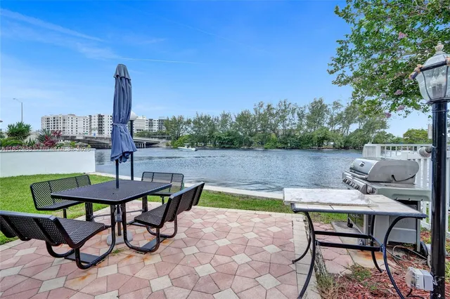 a living room with furniture large window and wooden floor