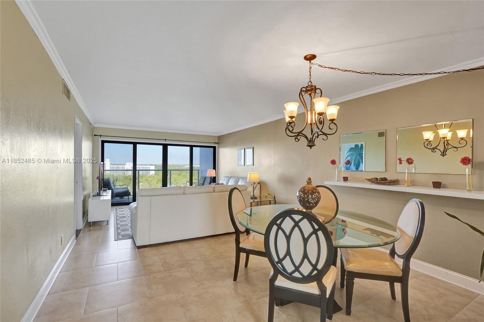 1401 North Riverside Drive, Unit 1005 Pompano Beach, FL 33062 - Photo 6 of 49 a dining room with wooden floor a chandelier a wooden table and chairs