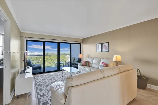 a living room with furniture and a floor to ceiling window