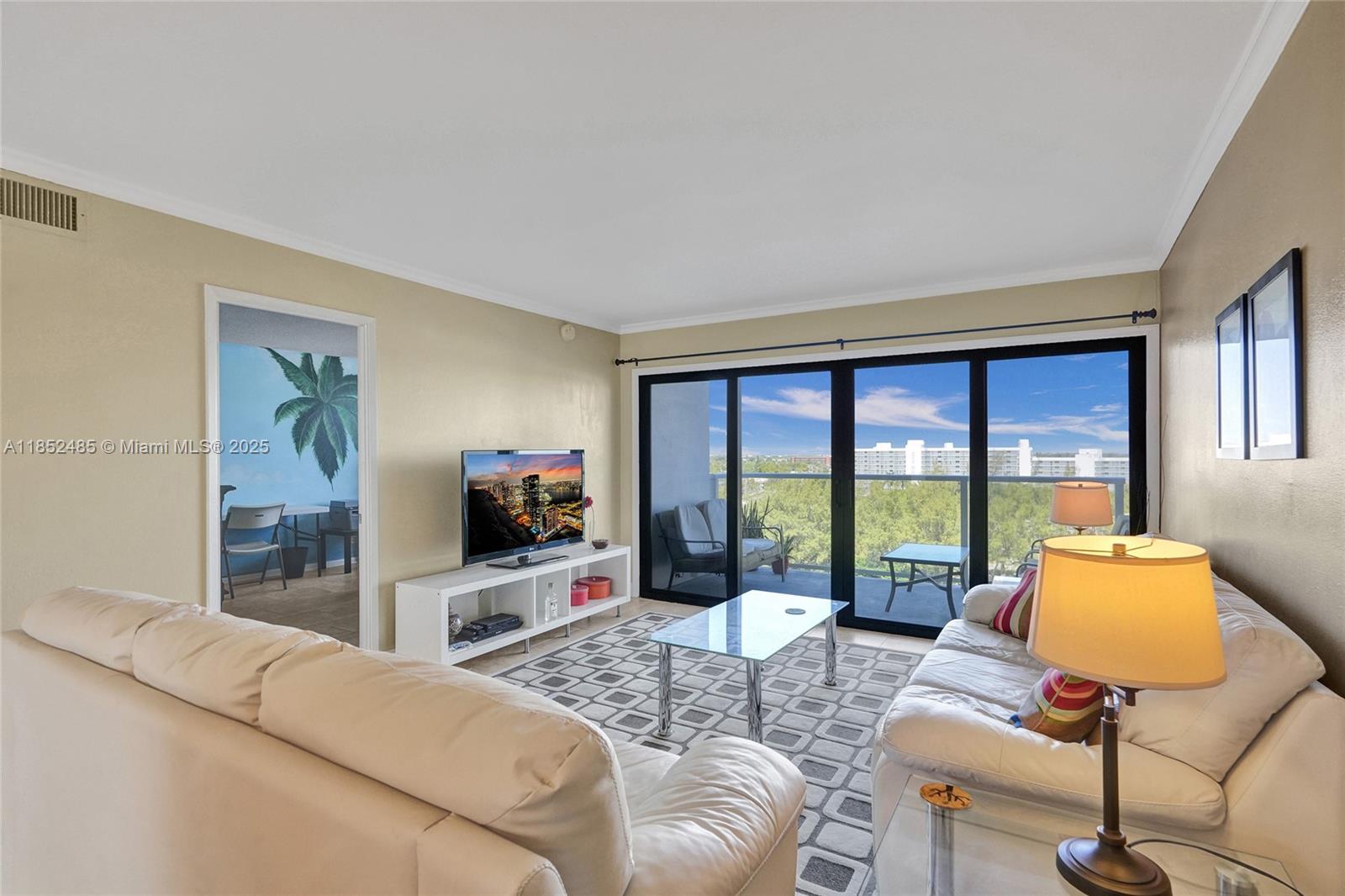 1401 North Riverside Drive, Unit 1005 Pompano Beach, FL 33062 - Photo 8 of 49 a living room with furniture and a flat screen tv