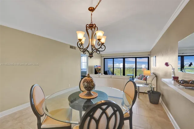 a view of a dining room with furniture a chandelier and wooden floor
