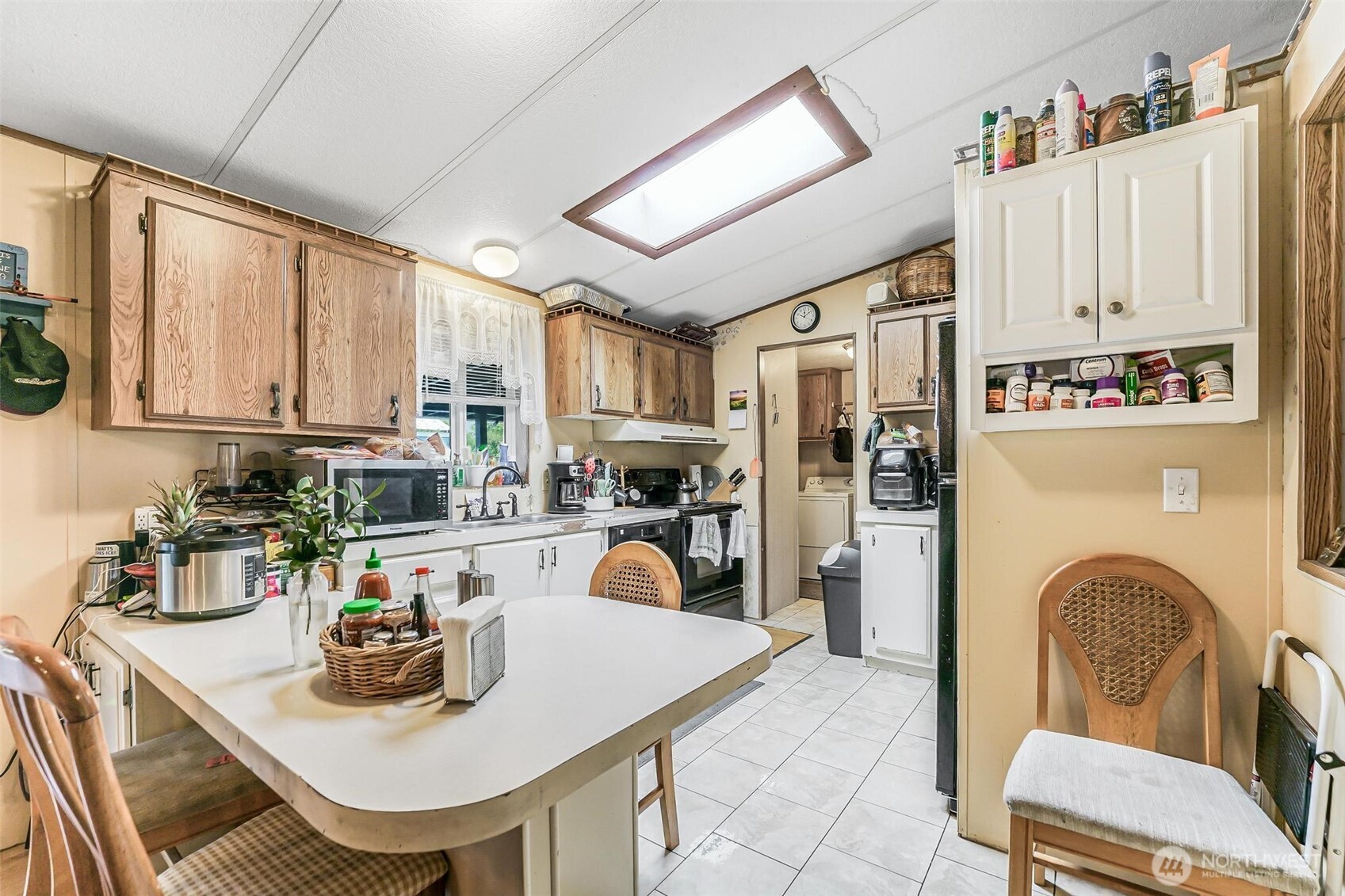 980 South Falcon Road Camano Island, WA 98282 - Photo 4 of 30 a kitchen with stainless steel appliances granite countertop a stove a sink dishwasher and a refrigerator with wooden cabinets