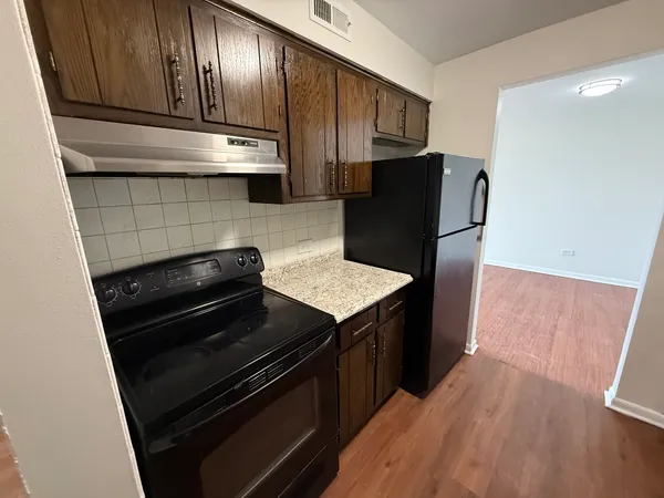 a kitchen with wooden cabinets and a sink