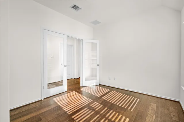 a view of bedroom with wooden floor
