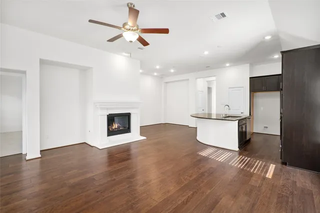 a view of a kitchen with a sink and a fireplace