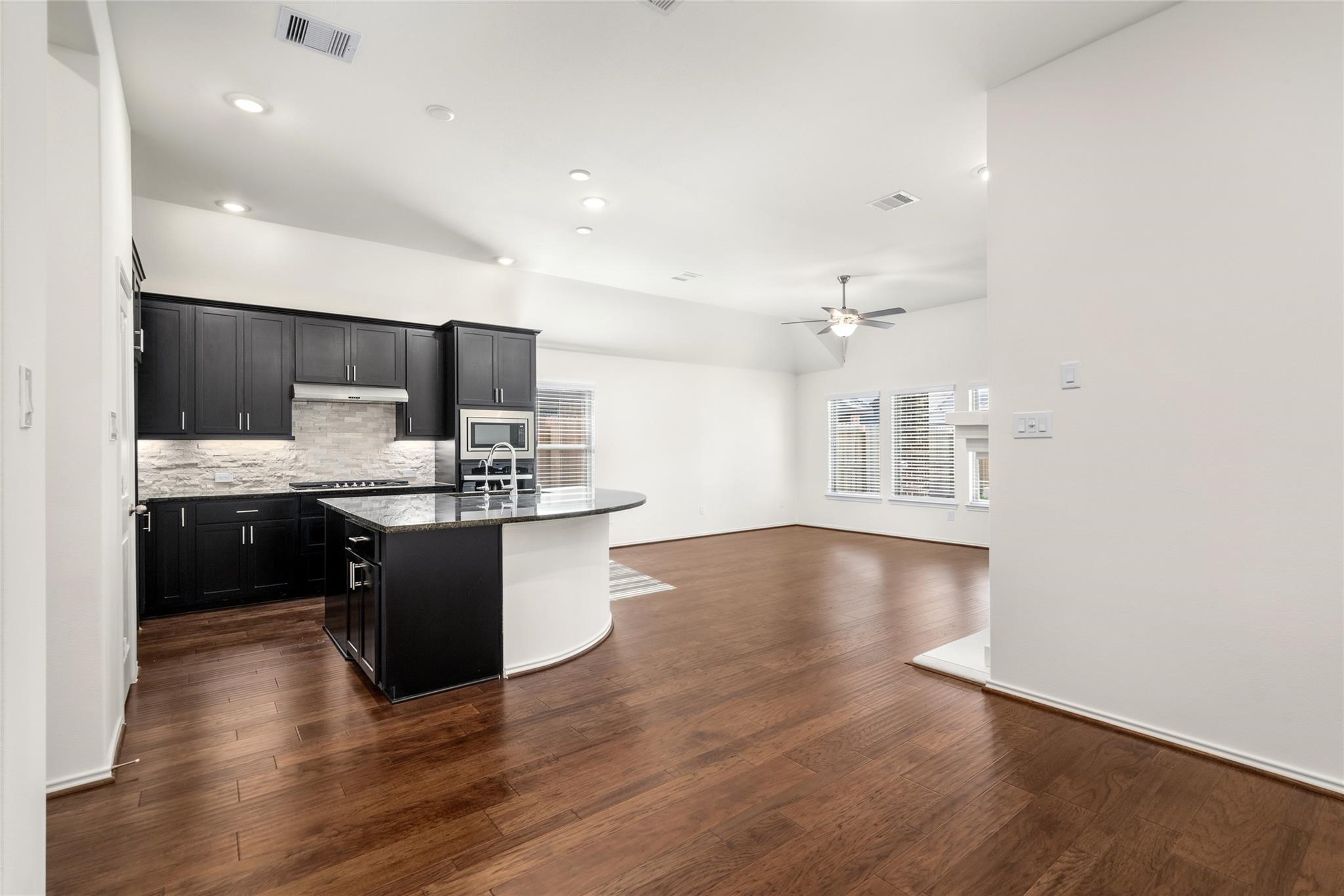 7480 Caprock Cyn Lane Porter, TX 77365 - Photo 5 of 13 a kitchen with stainless steel appliances kitchen island granite countertop a stove a sink and a refrigerator