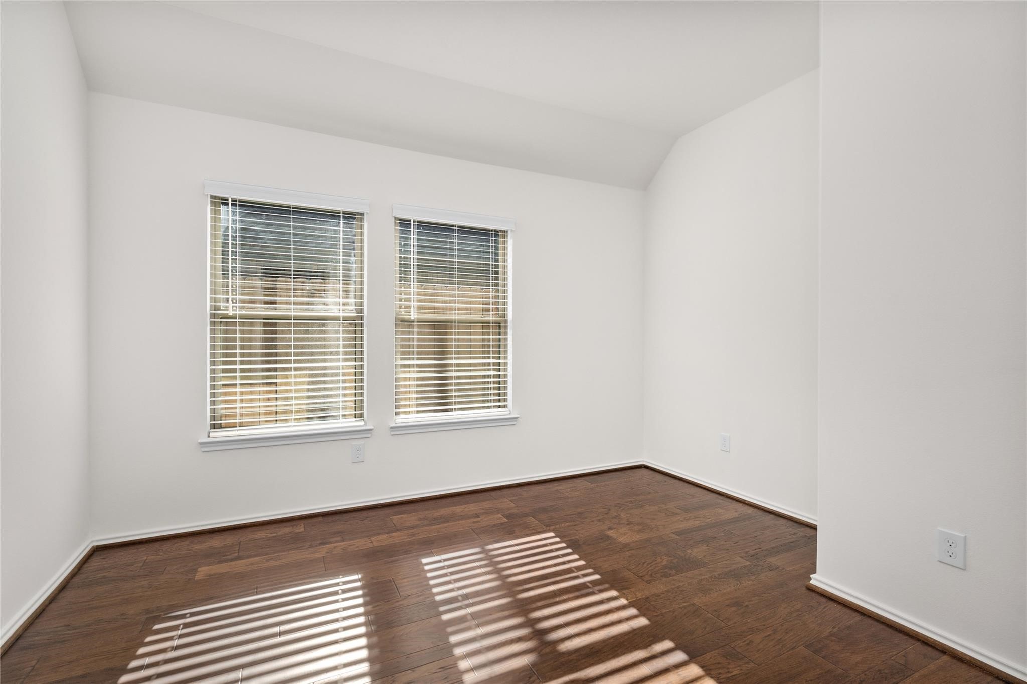 7480 Caprock Cyn Lane Porter, TX 77365 - Photo 9 of 13 a view of an empty room with wooden floor and a window