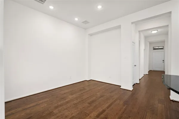 a view of wooden floor and windows in a room