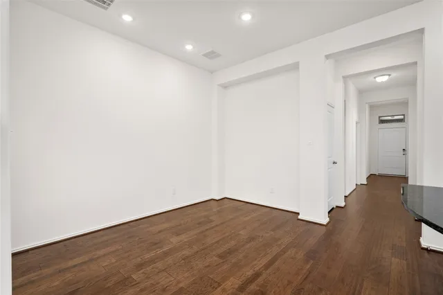 a view of wooden floor and windows in a room
