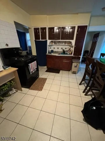 a kitchen with granite countertop a stove and cabinets