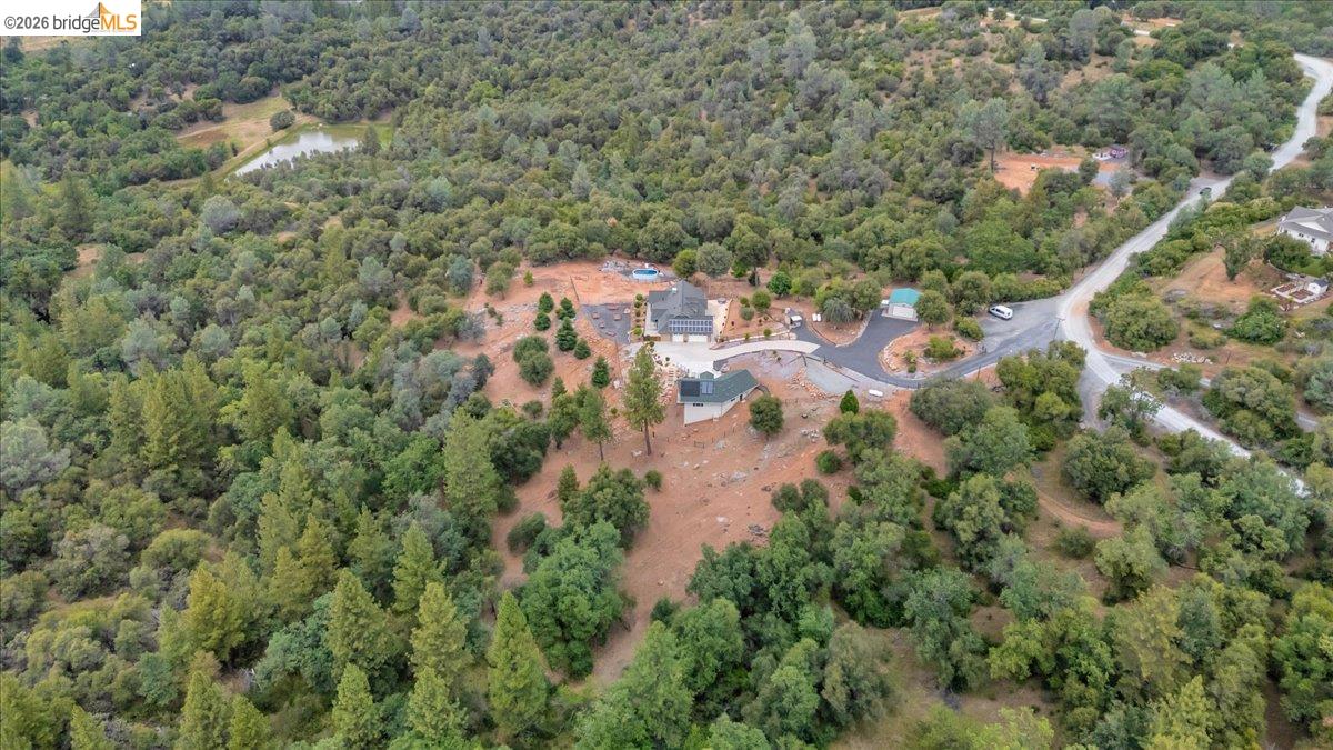 18180 Robin Ridge Road Sonora, CA 95370 - Photo 84 of 88 Expansive wooded property featuring a single-story residence, a detached garage, and a circular paved driveway