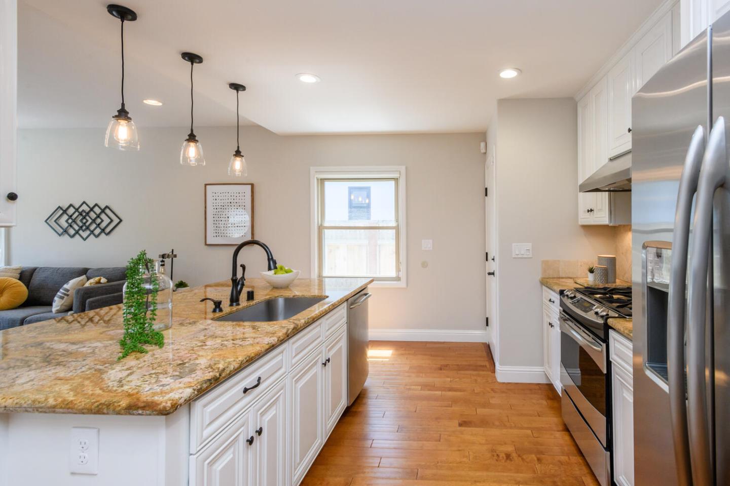 138 Channing Road Burlingame, CA 94010 - Photo 14 of 36 a kitchen with stainless steel appliances granite countertop a sink a stove and a wooden floors