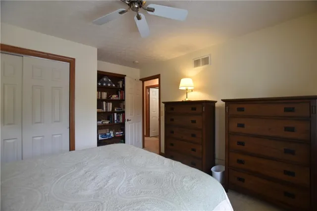 a large bedroom with a dresser and a mirror