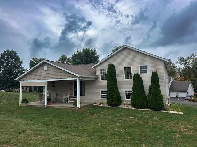a front view of a house with a garden