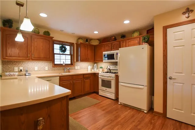 a kitchen with refrigerator cabinets and wooden floor