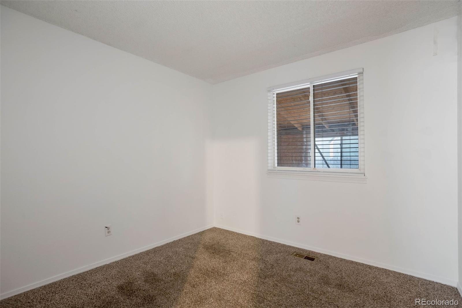 4437 Durham Court Denver, CO 80239 - Photo 11 of 15 an empty room with a window
