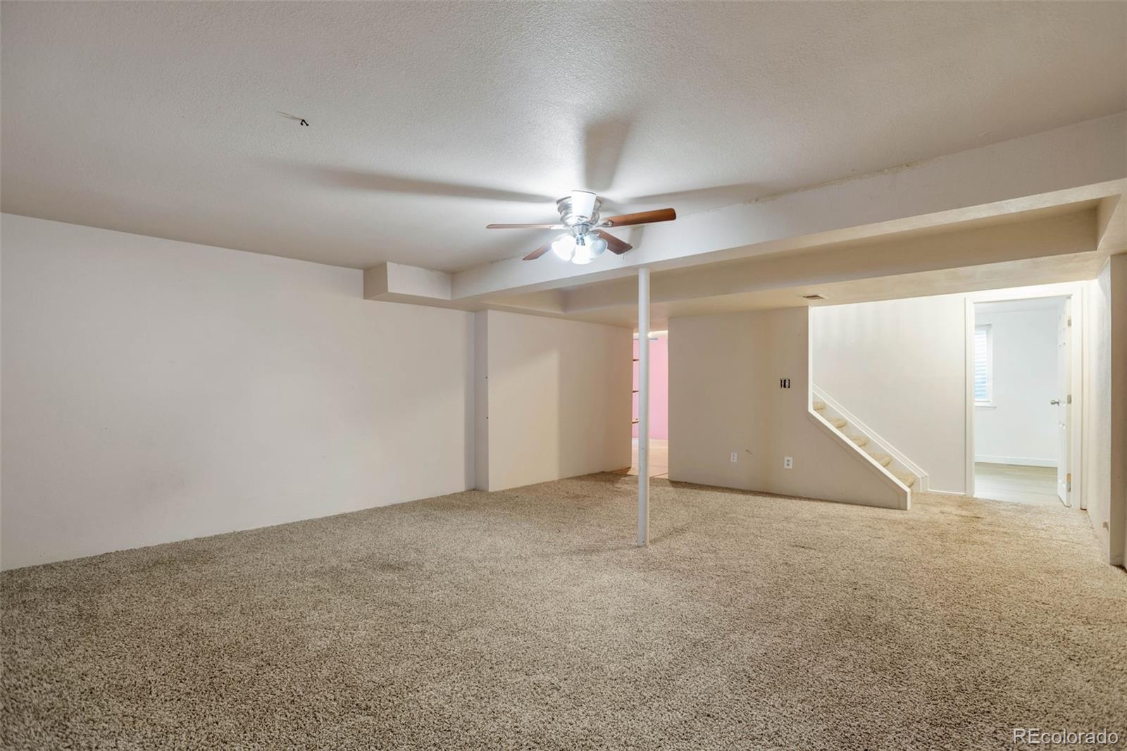 4437 Durham Court Denver, CO 80239 - Photo 13 of 15 an empty room with closet and ceiling fan