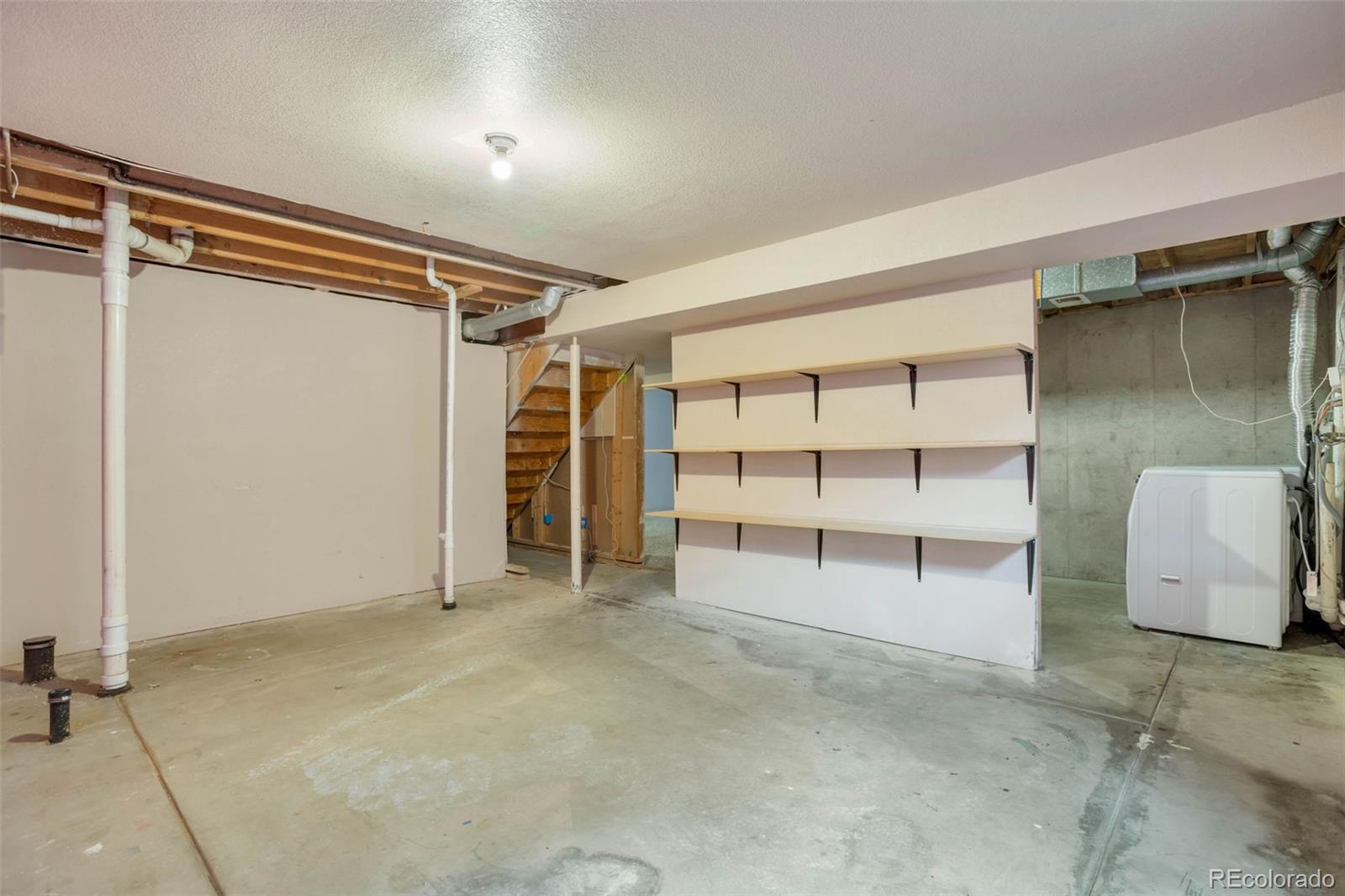 4437 Durham Court Denver, CO 80239 - Photo 14 of 15 a view of an empty room with a cabinet