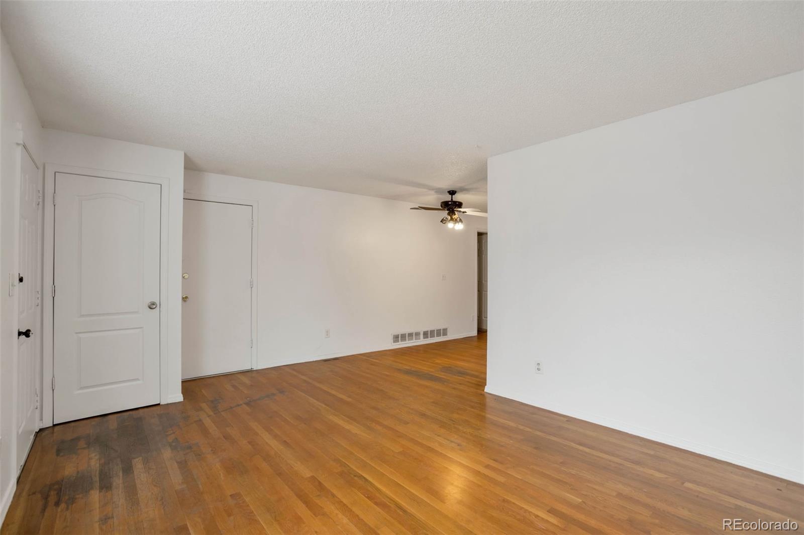 4437 Durham Court Denver, CO 80239 - Photo 2 of 15 a view of a room with wooden floor