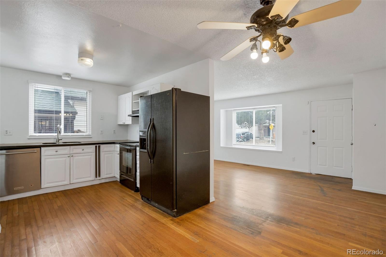 4437 Durham Court Denver, CO 80239 - Photo 5 of 15 a kitchen with stainless steel appliances granite countertop a refrigerator and a sink