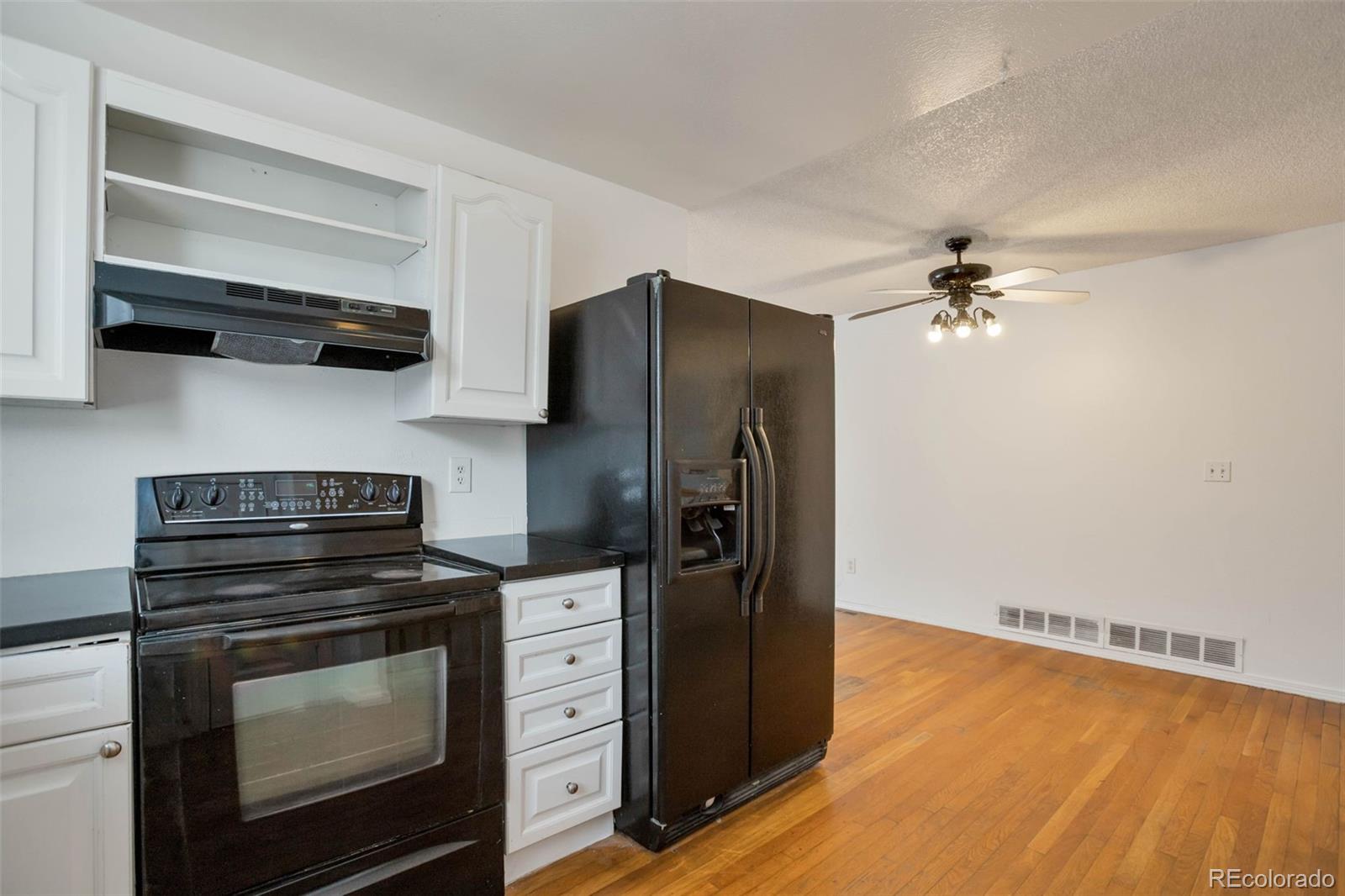 4437 Durham Court Denver, CO 80239 - Photo 6 of 15 a kitchen with stainless steel appliances a stove and a refrigerator
