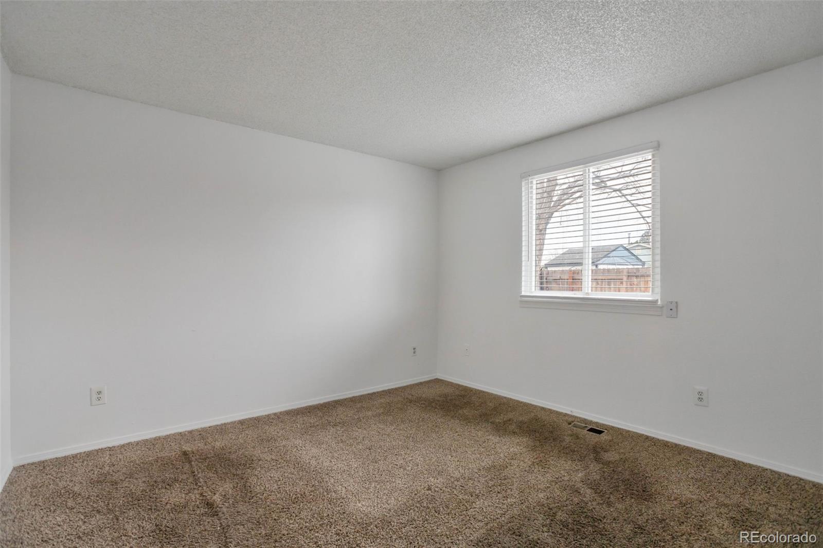 4437 Durham Court Denver, CO 80239 - Photo 8 of 15 an empty room with a window