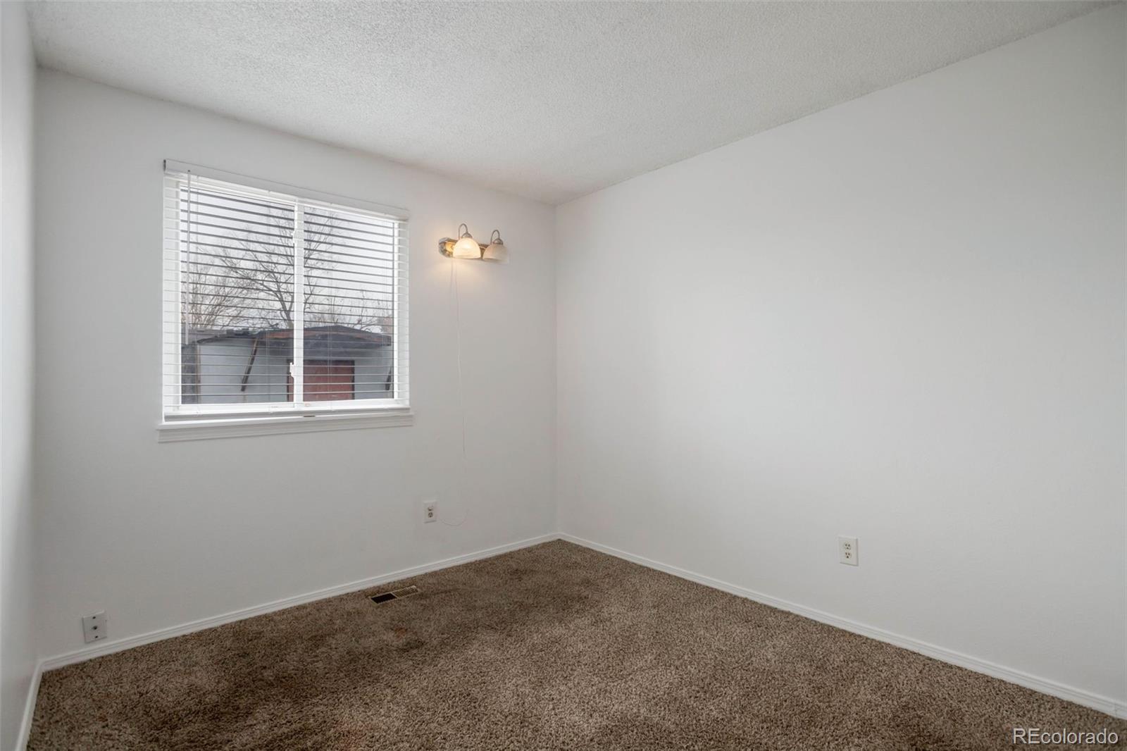4437 Durham Court Denver, CO 80239 - Photo 10 of 15 an empty room with a window