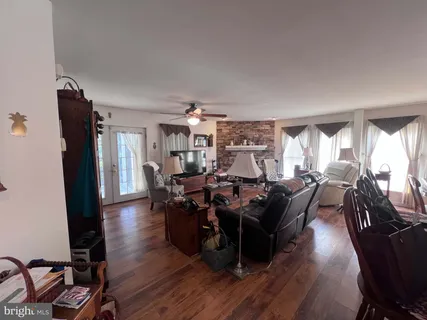 a living room with lots of furniture and wooden floor