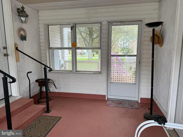 a view of an entryway with wooden floor and door