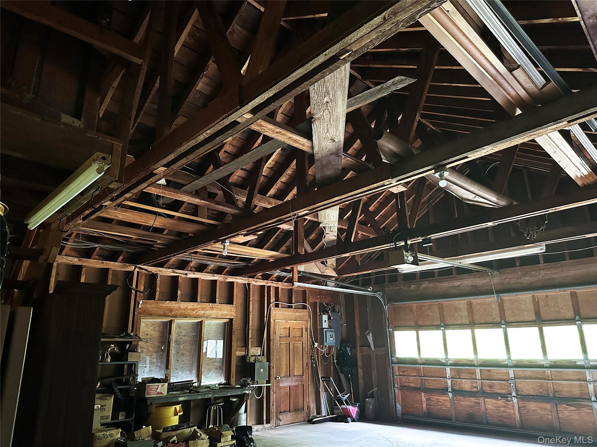 818 Methol Road Roscoe, NY 12776 - Photo 33 of 39 Oversized garage/workshop with soaring exposed trusses, substantial storage capacity, and space for equipment, hobbies, or recreational use.