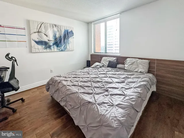 a large bed sitting in a bedroom next to a window
