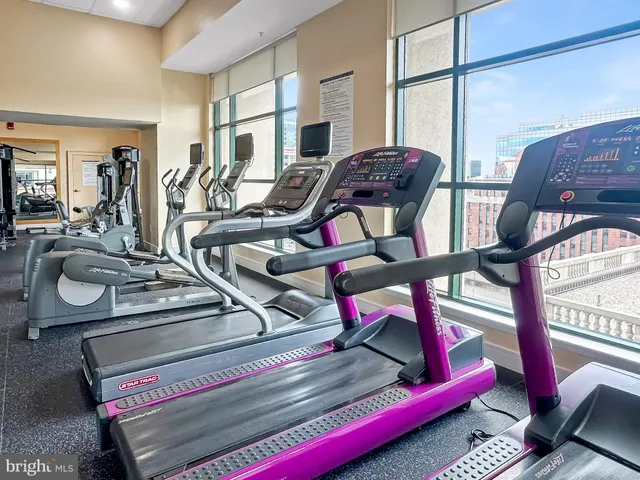 a room with pool table and windows