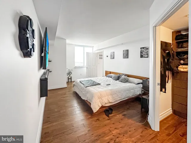 a spacious bedroom with a bed and a view of bathroom