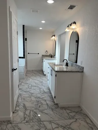 a bathroom with a sink and mirror
