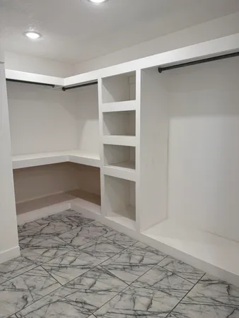 a view of an empty room and a window