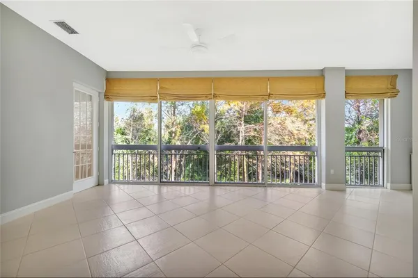a view of an empty room with furniture and floor to ceiling windows