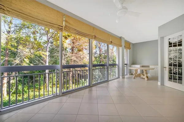 a view of an empty room and a chandelier fan