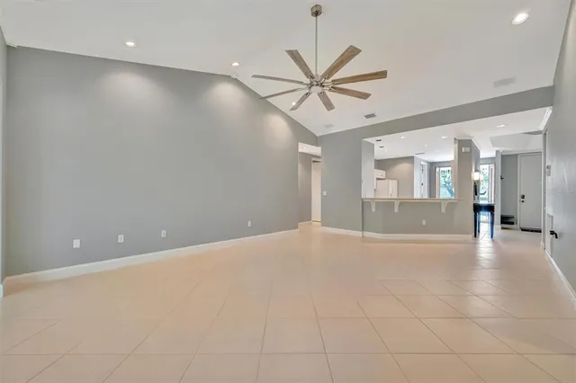 a kitchen that has a lot of white cabinets and stainless steel appliances