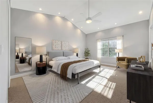 a bedroom with bed and a couch with window