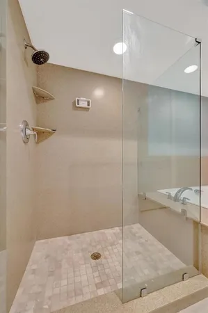 an empty room with windows and flat screen tv