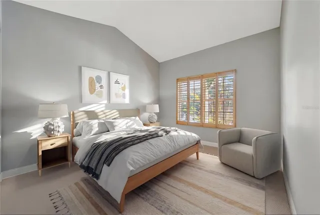 a living room with furniture and potted plants