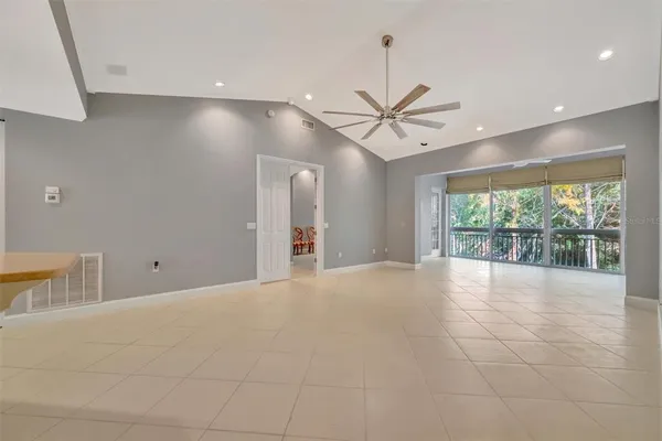 a view of a dining room with furniture large windows and wooden floor