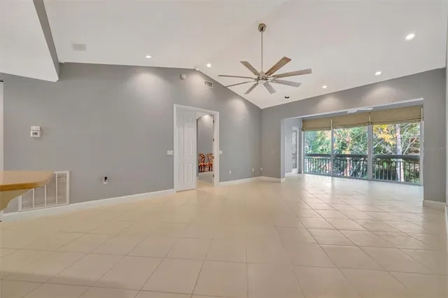 a view of a dining room with furniture large windows and wooden floor