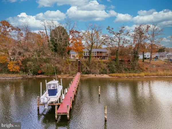 a view of a livingroom with furniture wooden floor fan and windows