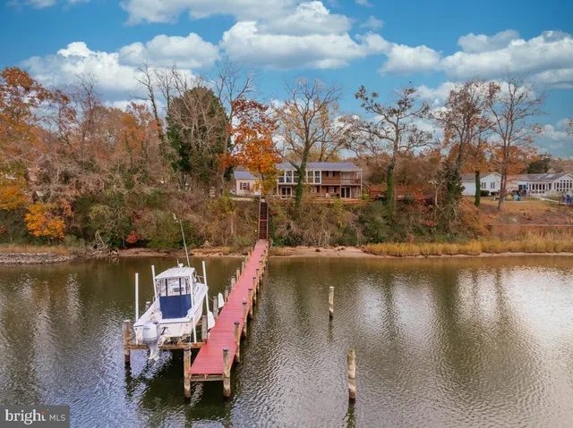 a view of a livingroom with furniture wooden floor fan and windows