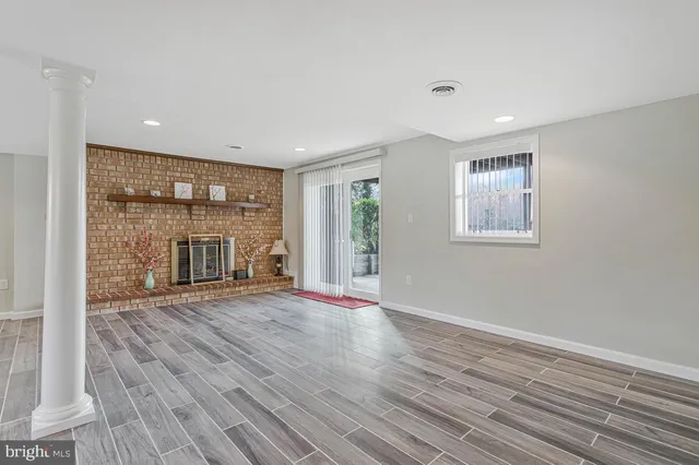 a view of a patio with table and chairs with wooden floor and fence