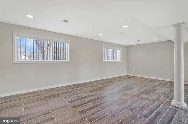 a view of an empty room and wooden floor