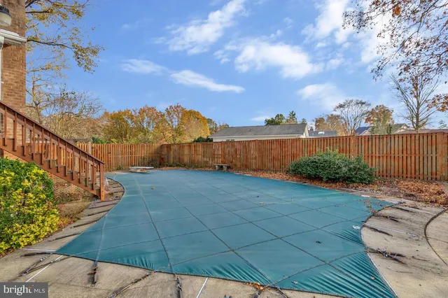 a view of a lake with boats and large trees